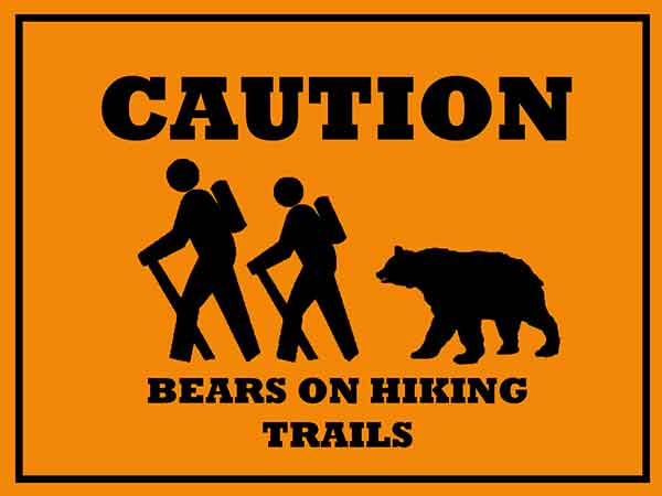 photo of a sign on caution bears on hiking trails near a campground