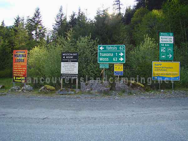photo of signage showing the way to Tahsis and Cougar Creek Recreation Site to the left and Muchalat Lake and Woss to the right