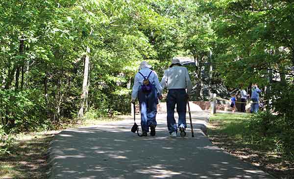 photo of an older couple walking trails when camping is fun