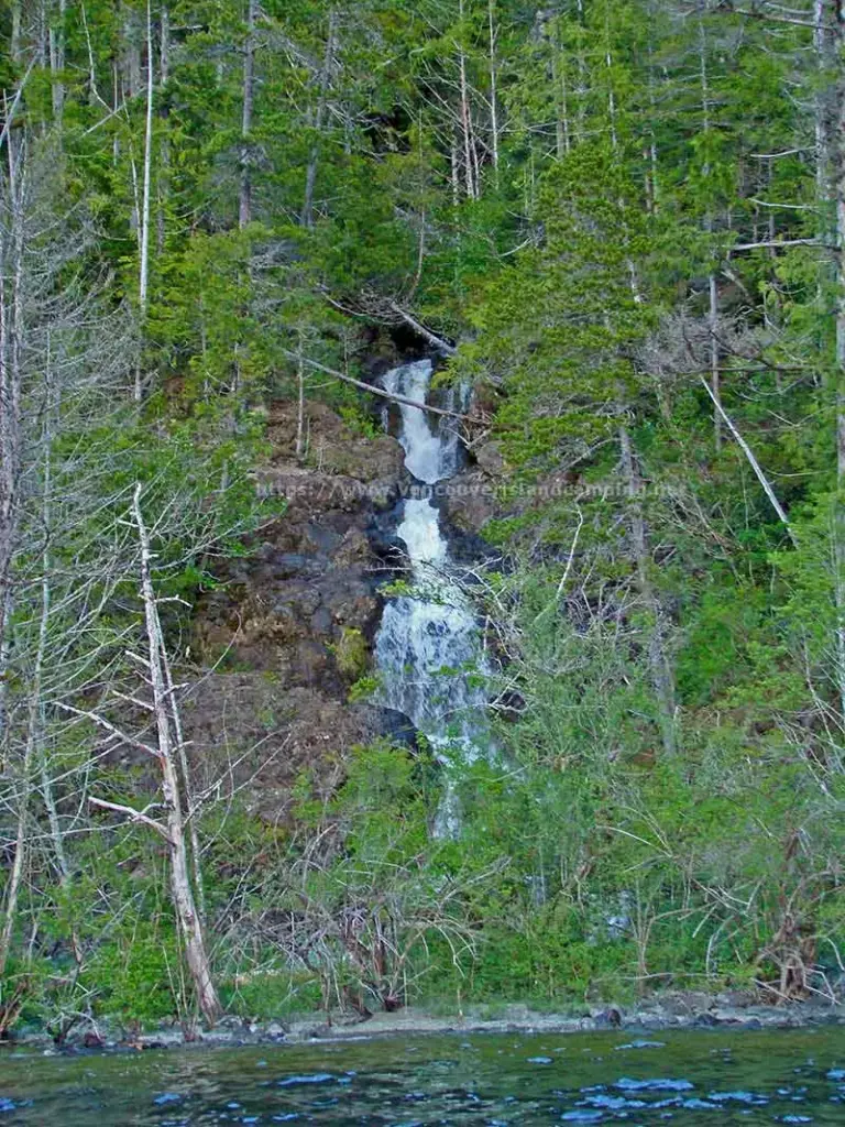 photo of a waterfall on the shoreline of Atluck Lake on Vancouver island