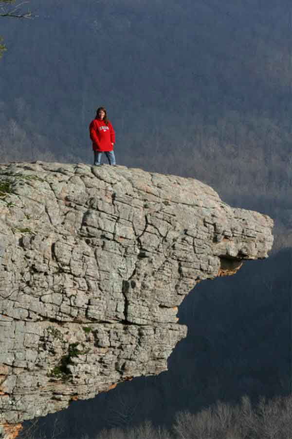 photo of a hiker on a rock outcropping is an example of camping tips and tricks every explorer should know