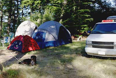 photo of a family campground including the dog if you were wondering how to prepare for a camping trip