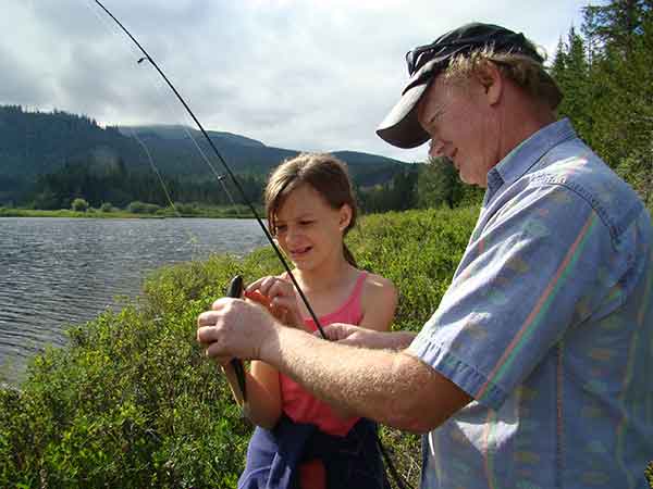 photo of myself helping my niece unhook the trout she just caught 
