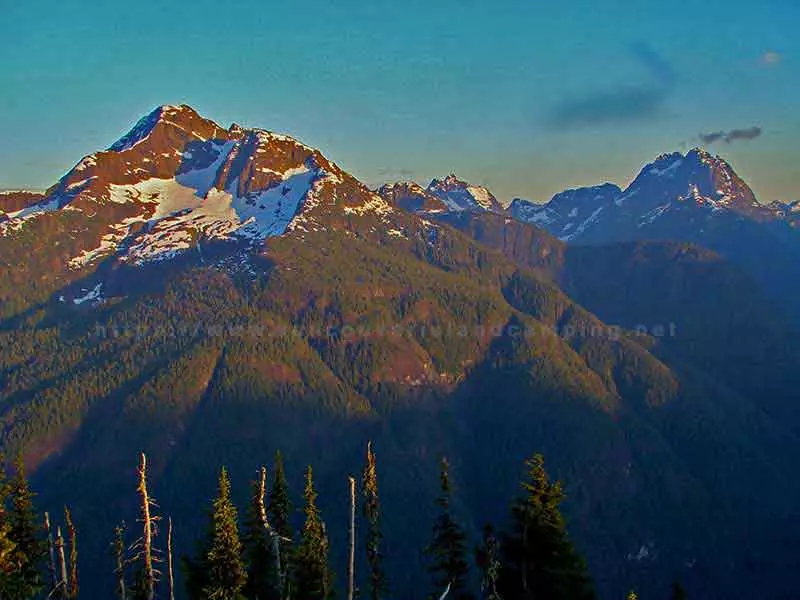 photo of an early morning sunrise over the mountain peaks of Strathcona Park on Vancouver Island from atop of Crest Mountain Trail