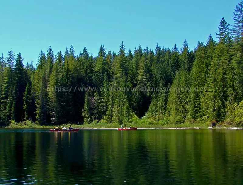 photo of paddlers in canoes using the portage route on Gosling Lake