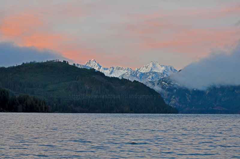 photo of a beautiful early morning sunrise over Upper Campbell Lake with Elkhorn Mountain and Kings Peak in the background.