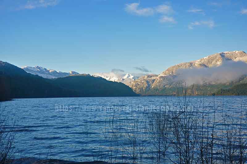 photo of the snow capped mountains from my camper door at the Upper Campbell Reservoir Campground on Vancouver Island, BC Canada