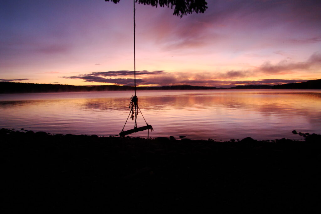 Photo of the rope swing at sunset at Fir Grove Recreation Site on Vancouver Island British Columbia Canada