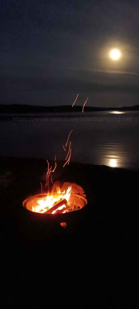 Photo of a full moon shining over Lower Campbell Lake at Fir Grove Recreation Site on Vancouver Island British Columbia Canada