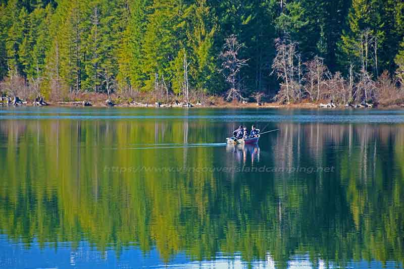 photo of a local father and 3 sons fishing in front of Loon Bay on Vancouver Island, British Columbia Canada