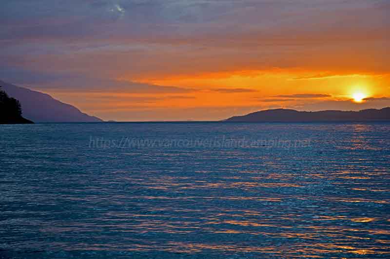 Photo of a sunset over Johnstone Strait from Naka Creek Campground on Vancouver Island British Columbia, Canada